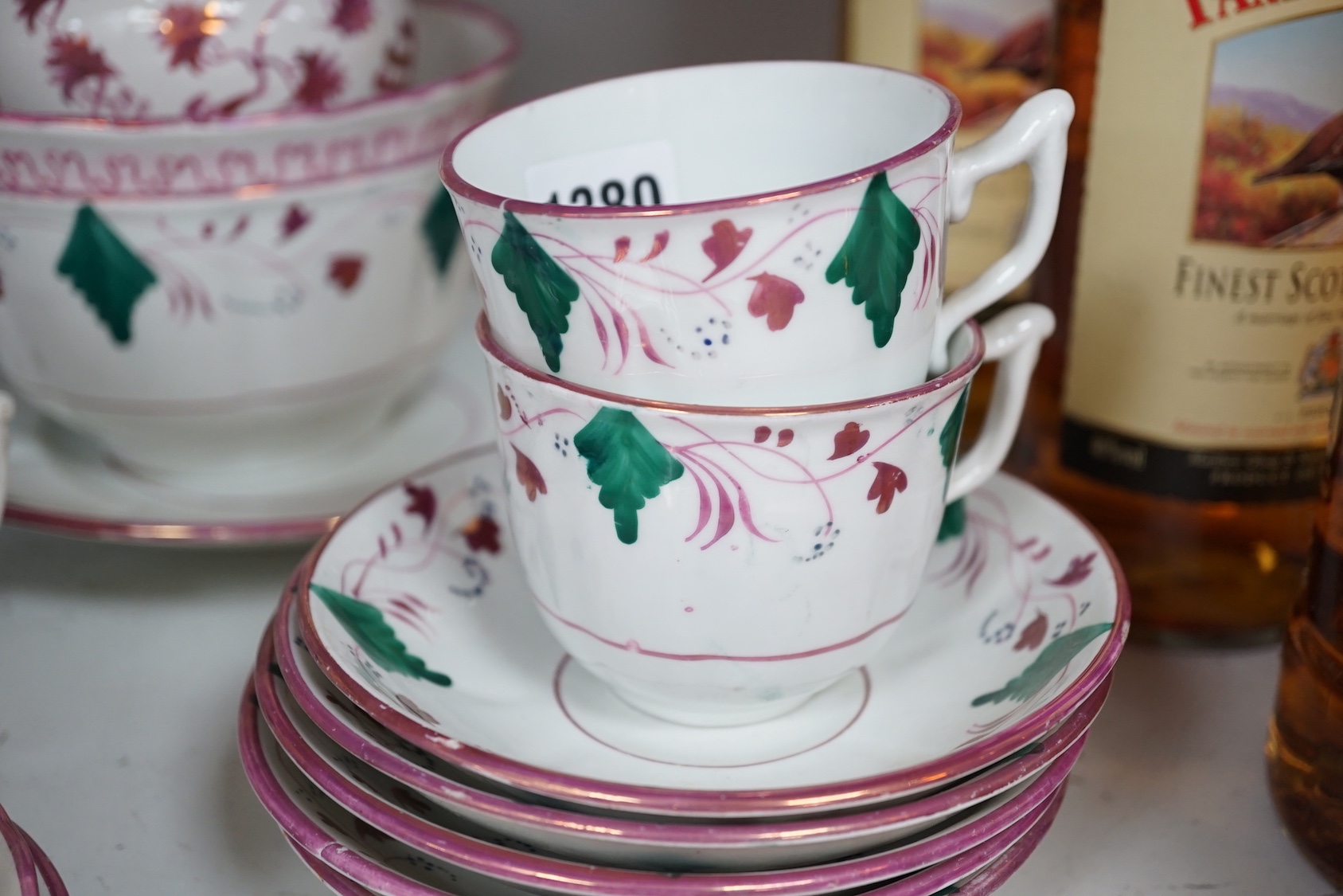 A collection of Welsh or English pink lustre pottery tea wares, first half 19th century
